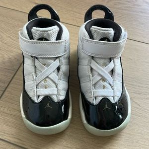 Toddler black, white and gold Jordans 8C